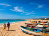 Santa Maria beach in Sal Island with fishing boats, tourists and everyday coastal life