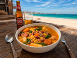 Traditional Cape Verdean cachupa served at a beach bar in Sal Island with beer and ocean view